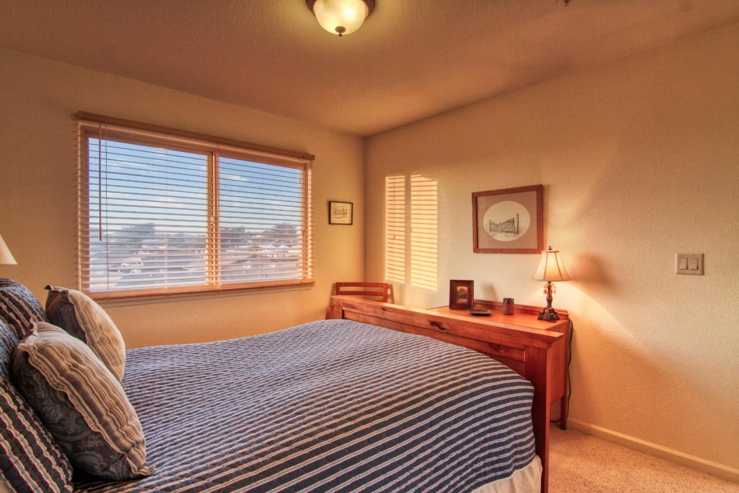 146 Katerina Lane Marina, CA 93933 - Photo 21 of 23 a bedroom with a bed and a window