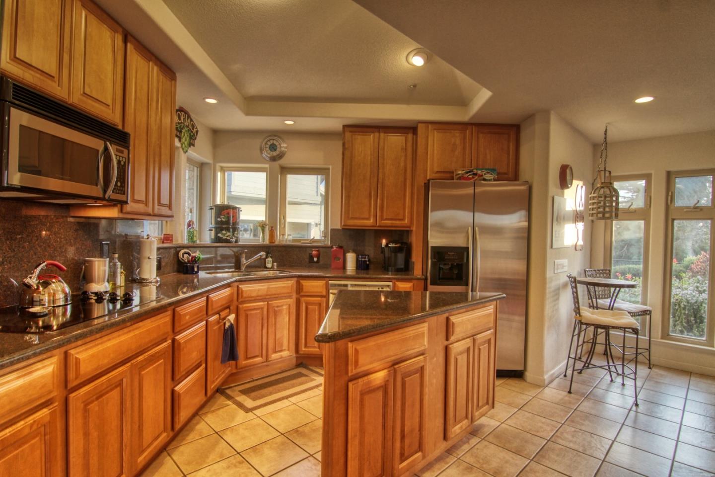 146 Katerina Lane Marina, CA 93933 - Photo 5 of 23 a kitchen with stainless steel appliances granite countertop a refrigerator and a sink
