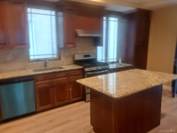 a kitchen with granite countertop a sink and a stove