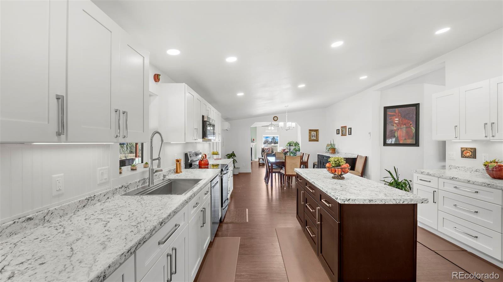 12340 Smith Road Peyton, CO 80831 - Photo 12 of 49 a kitchen with stainless steel appliances a sink stove and cabinets