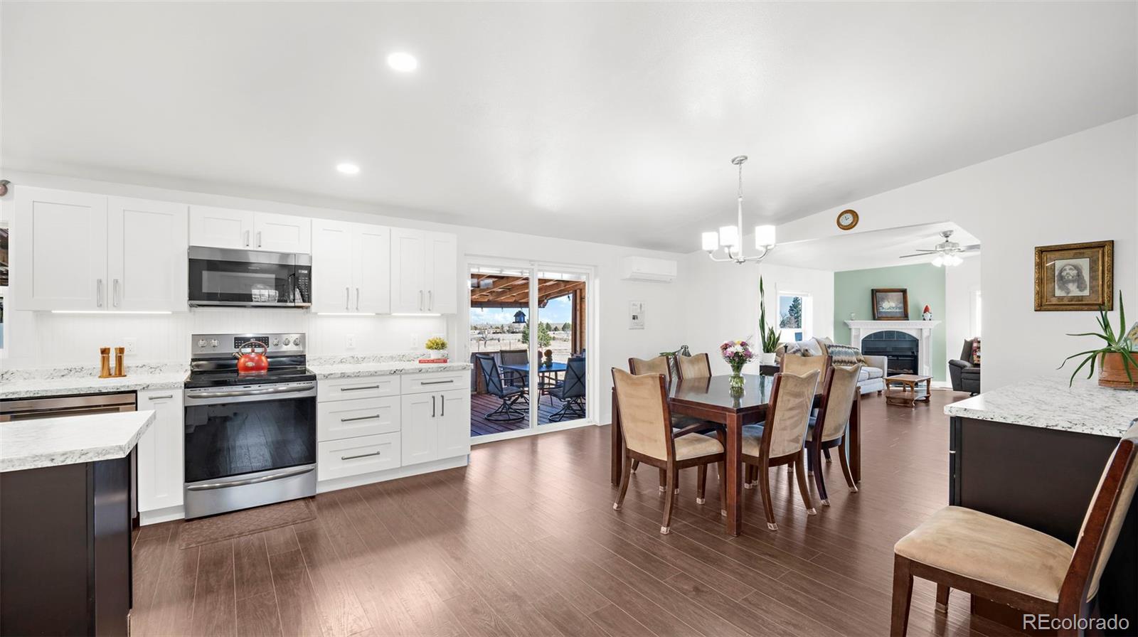 12340 Smith Road Peyton, CO 80831 - Photo 14 of 49 a view of a dining room with furniture window and wooden floor