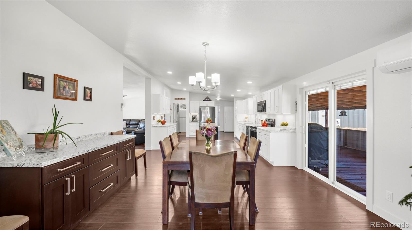 12340 Smith Road Peyton, CO 80831 - Photo 16 of 49 a view of a dining room with furniture and wooden floor