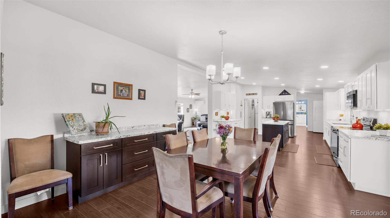 12340 Smith Road Peyton, CO 80831 - Photo 17 of 49 a view of a dining room with furniture and wooden floor