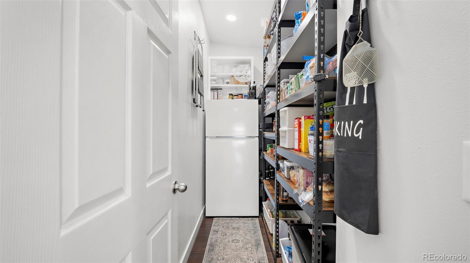 12340 Smith Road Peyton, CO 80831 - Photo 18 of 49 a view of walk in closet with clothes and shoes