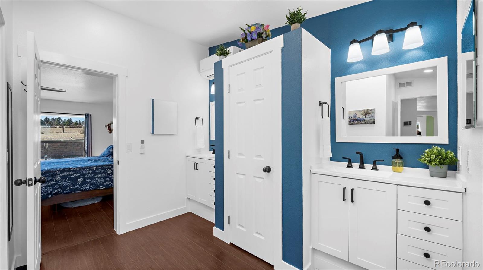 12340 Smith Road Peyton, CO 80831 - Photo 27 of 49 a bathroom with a double vanity sink and a mirror