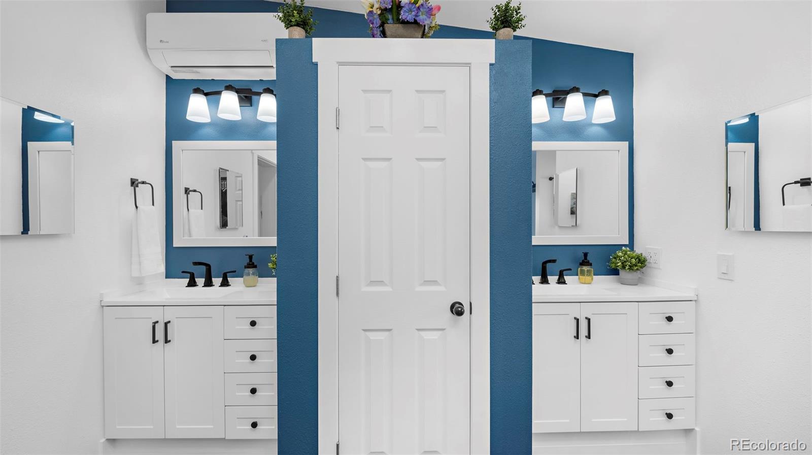 12340 Smith Road Peyton, CO 80831 - Photo 28 of 49 a bathroom with a sink vanity and a mirror