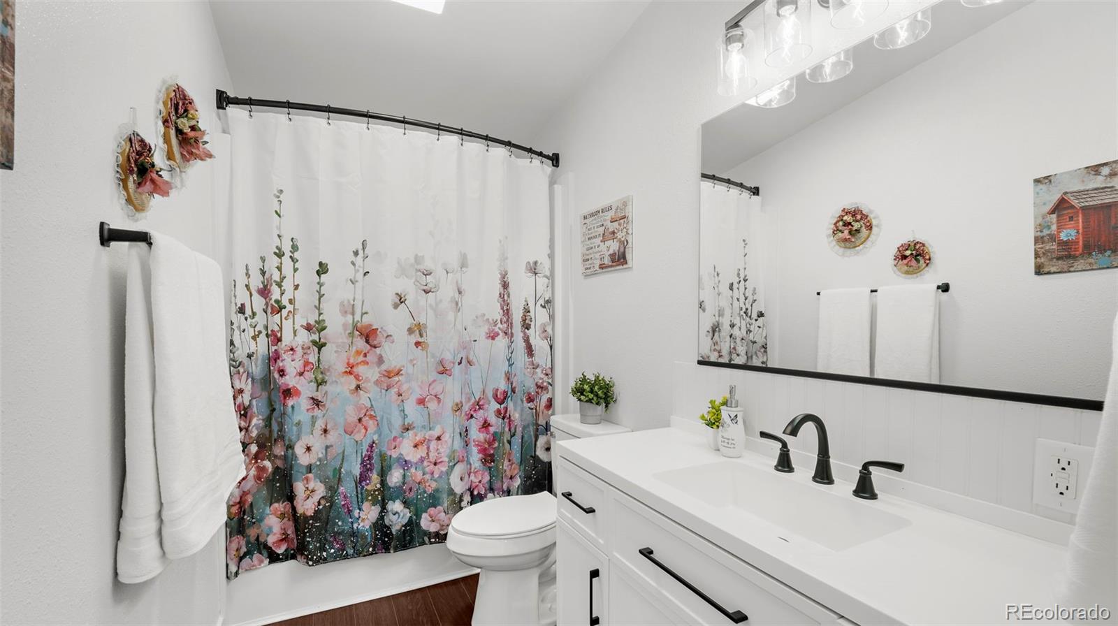 12340 Smith Road Peyton, CO 80831 - Photo 29 of 49 a bathroom with a sink toilet and shower