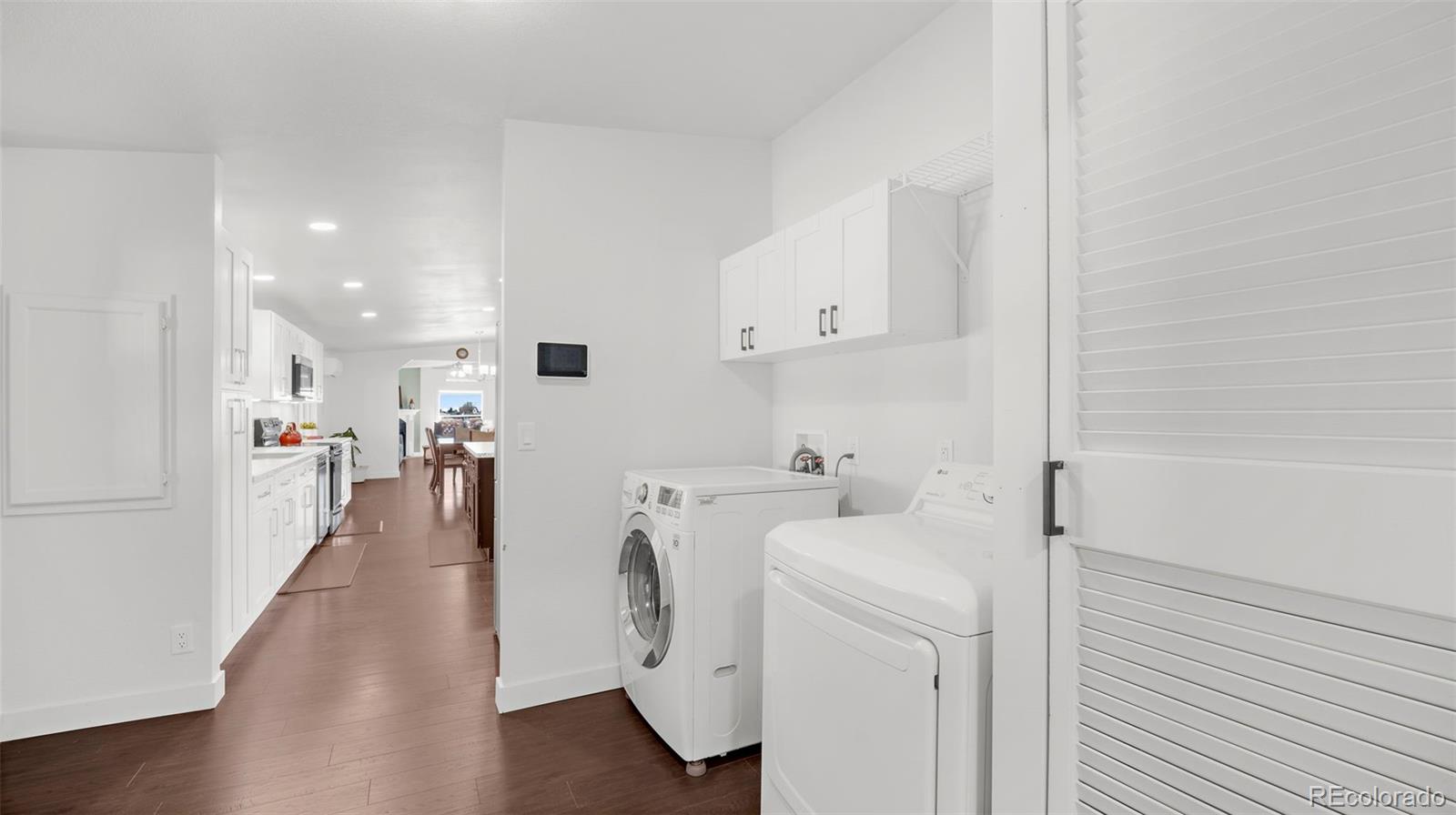 12340 Smith Road Peyton, CO 80831 - Photo 31 of 49 a view of storage and utility room with washer and dryer