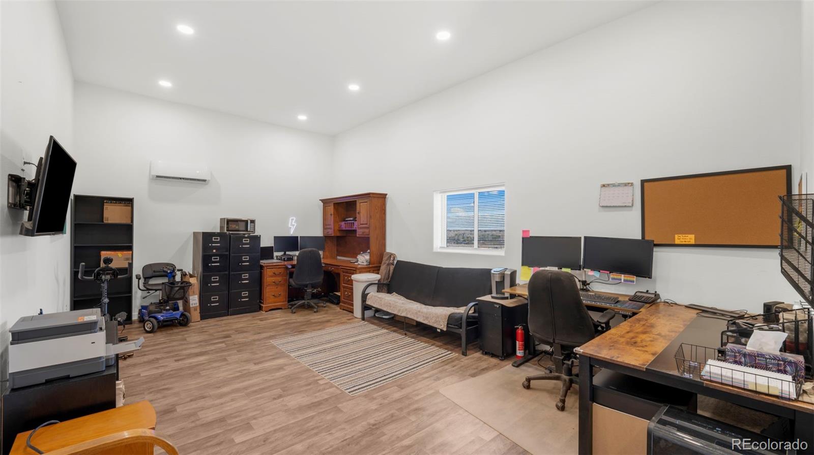 12340 Smith Road Peyton, CO 80831 - Photo 32 of 49 a bedroom with furniture and a flat screen tv