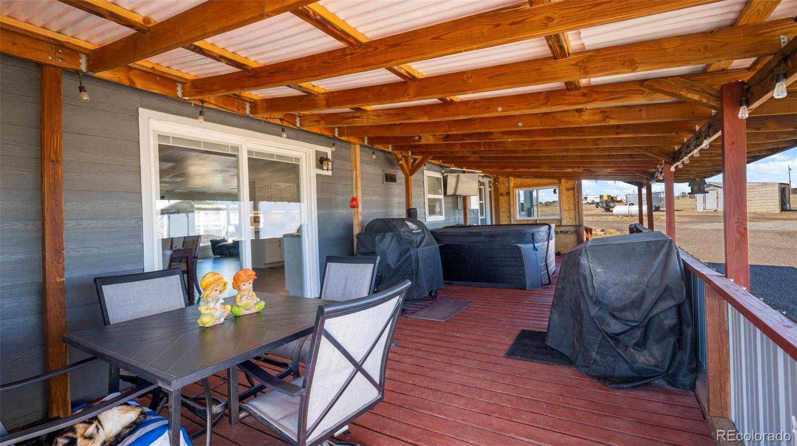12340 Smith Road Peyton, CO 80831 - Photo 35 of 49 a view of a chairs and table in a patio