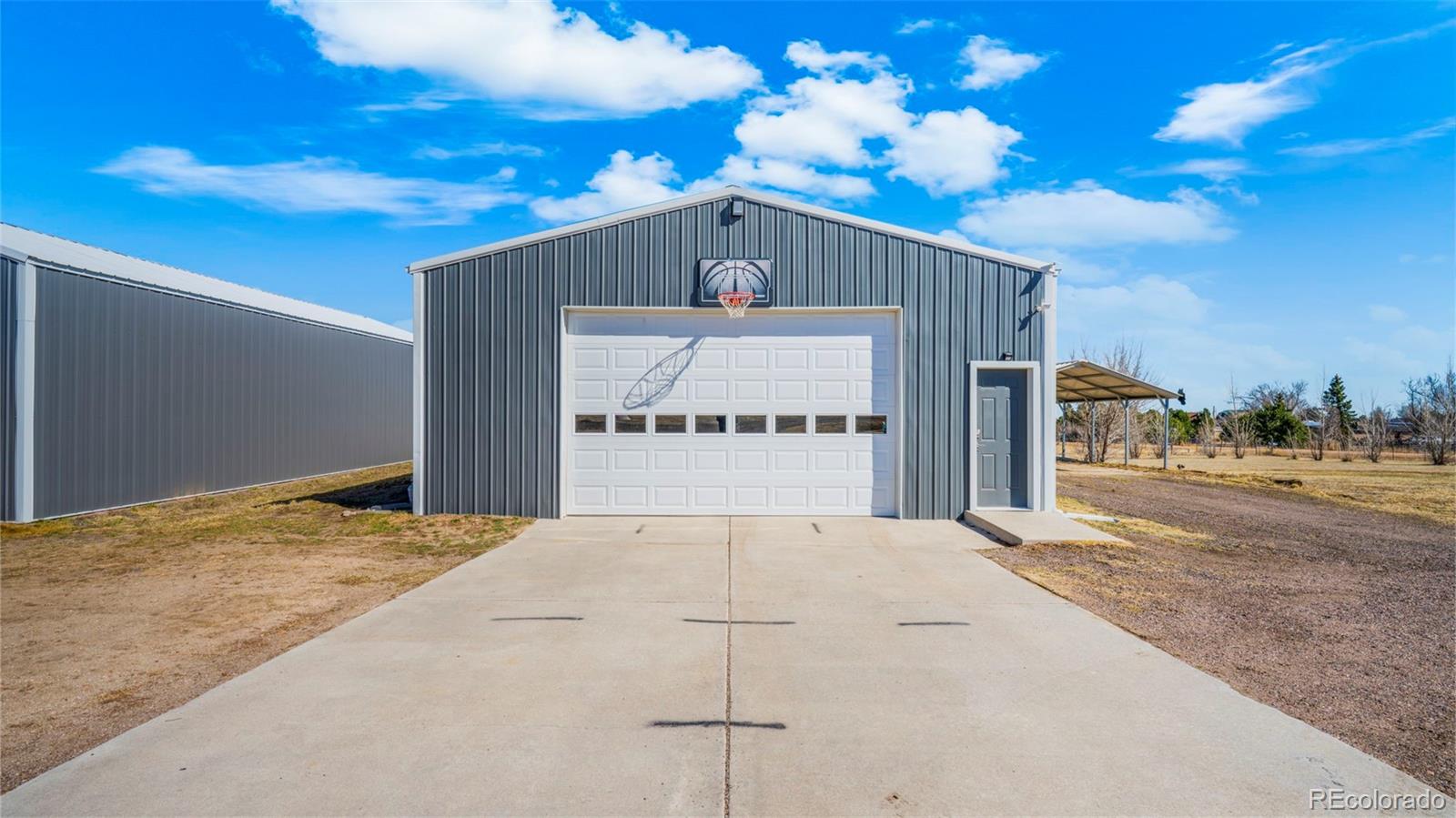 12340 Smith Road Peyton, CO 80831 - Photo 39 of 49 a front view of a house with a yard
