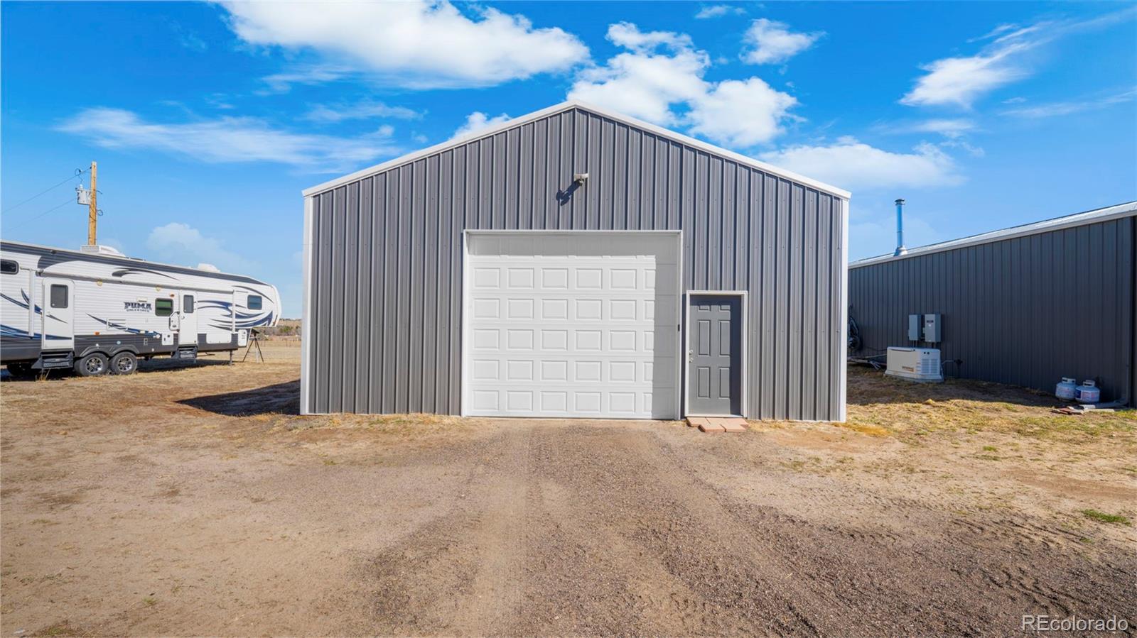 12340 Smith Road Peyton, CO 80831 - Photo 41 of 49 a view of a house with a outdoor space