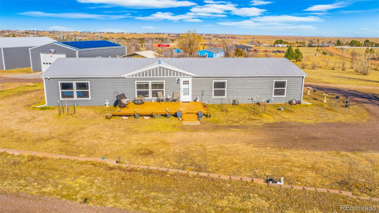 12340 Smith Road Peyton, CO 80831 - Photo 48 of 49 a front view of house with yard and ocean