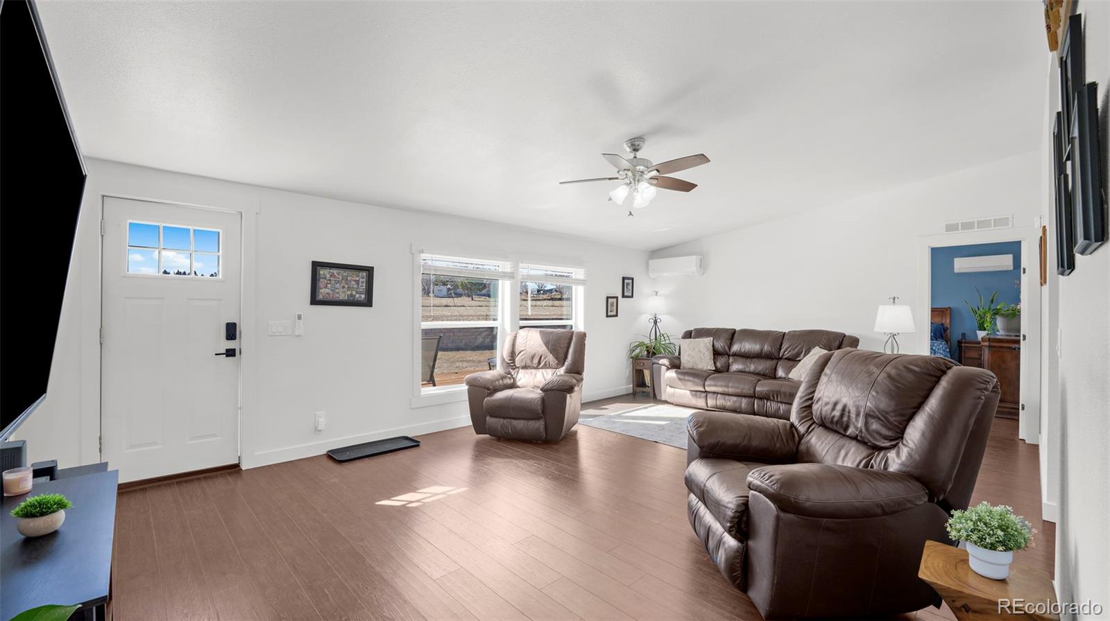 12340 Smith Road Peyton, CO 80831 - Photo 5 of 49 a living room with furniture and wooden floor