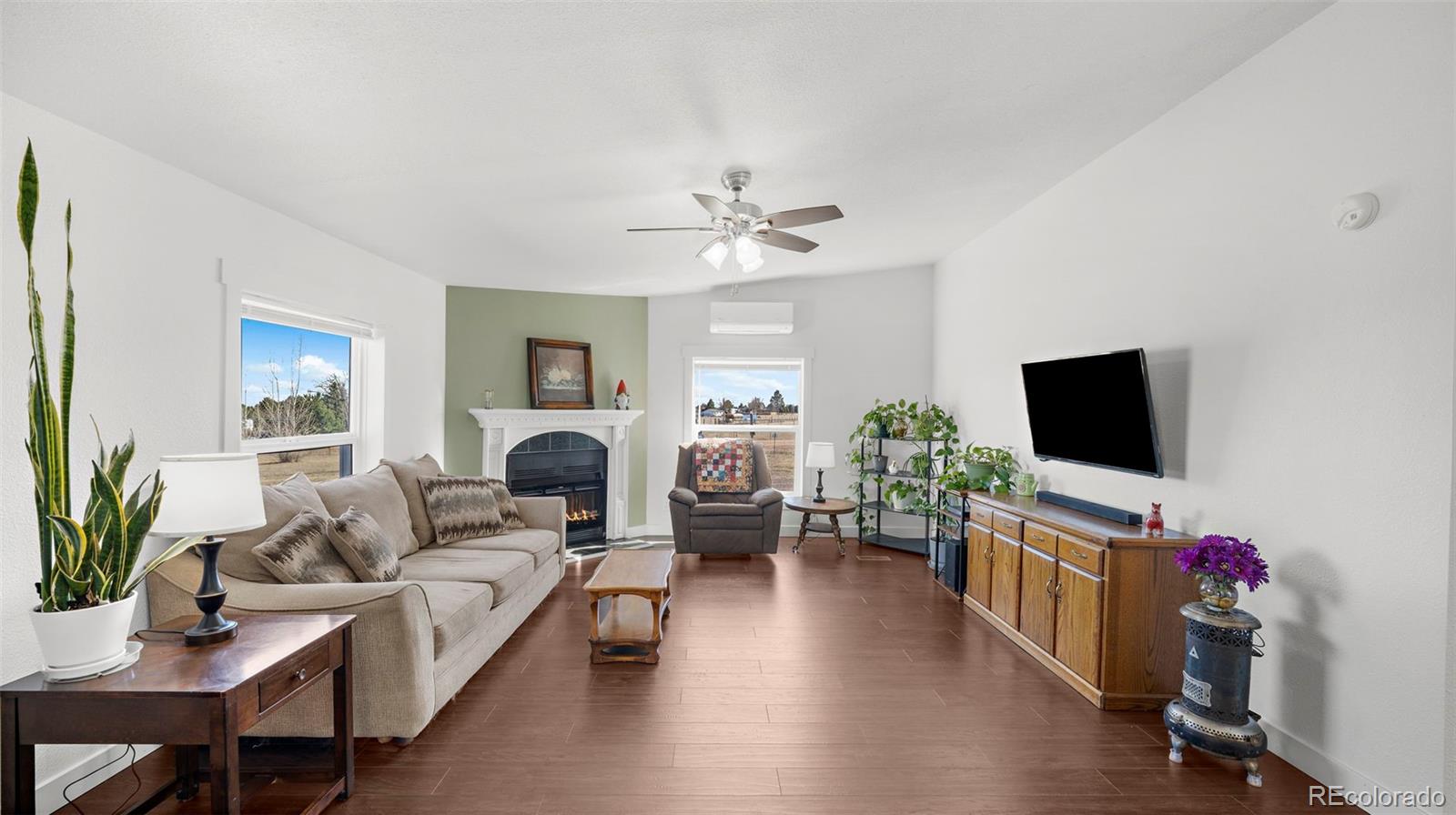 12340 Smith Road Peyton, CO 80831 - Photo 6 of 49 a living room with furniture and a flat screen tv