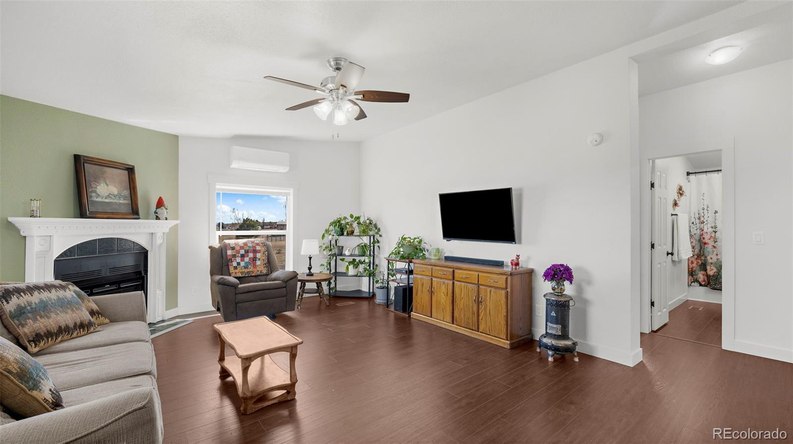 12340 Smith Road Peyton, CO 80831 - Photo 8 of 49 a living room with furniture and a flat screen tv