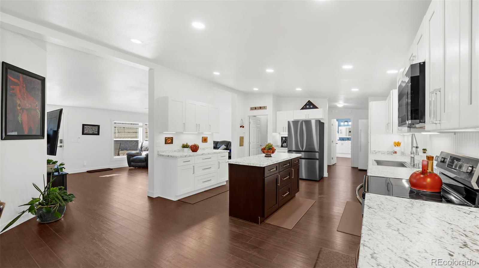 12340 Smith Road Peyton, CO 80831 - Photo 10 of 49 a large white kitchen with stainless steel appliances