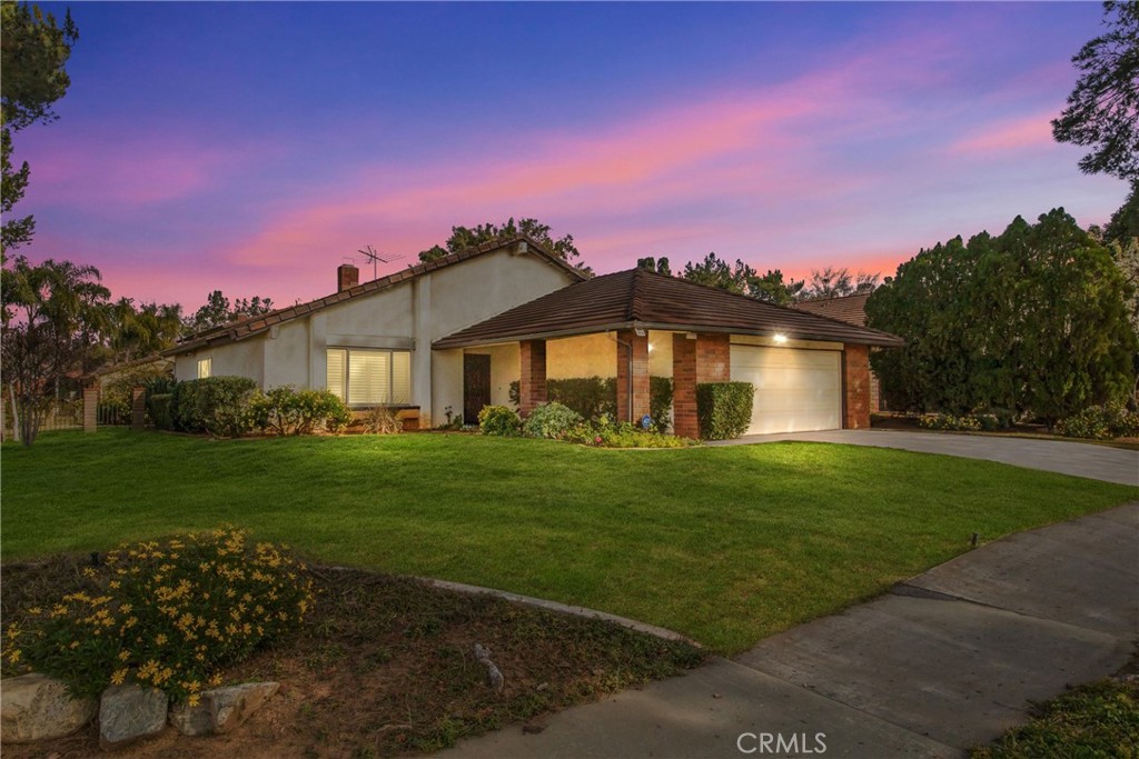 a front view of a house with a garden