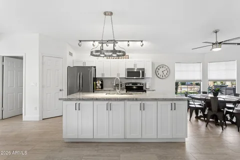 a view of a kitchen center island and living room
