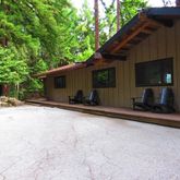 a backyard of a house with barbeque oven and outdoor seating