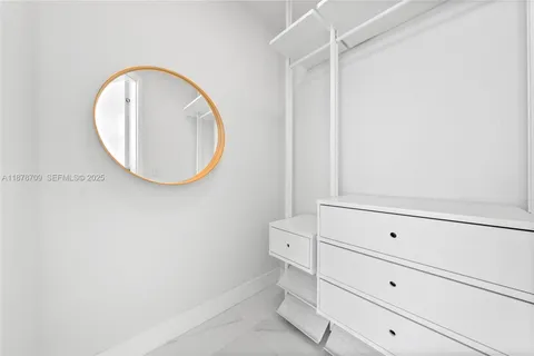 a front view of a mirror and vanity
