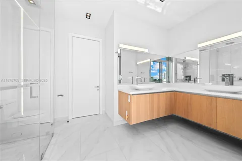 a large white bathroom with a sink a mirror and a bathtub