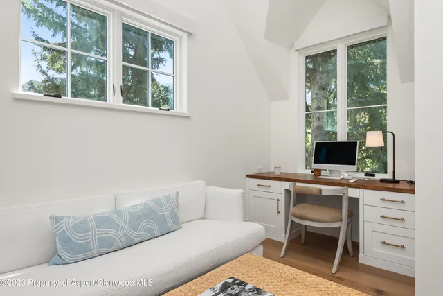 a bedroom with bed and a large window