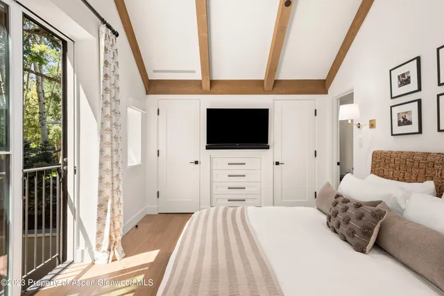 a bedroom with a bed and a large window