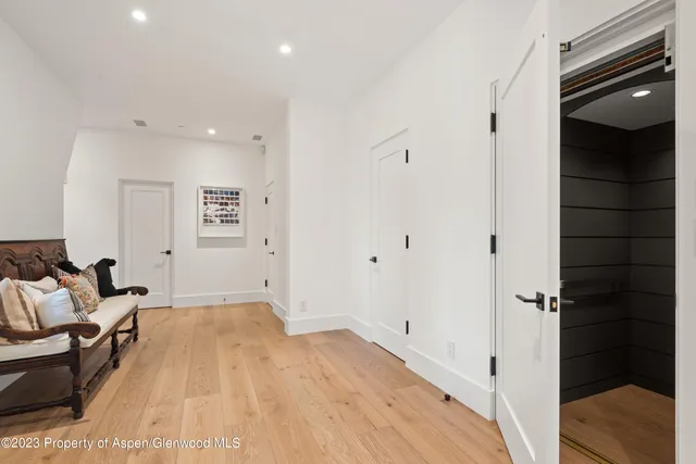 a bedroom with two beds and a flat screen tv