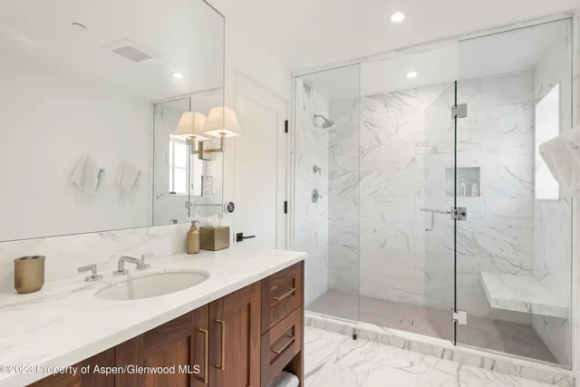 a kitchen with granite countertop a stove a sink and a wooden cabinets