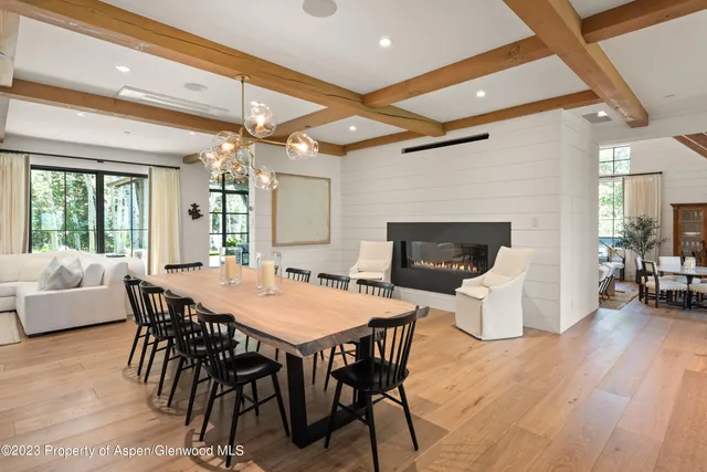 a view of a patio with table and chairs under an umbrella