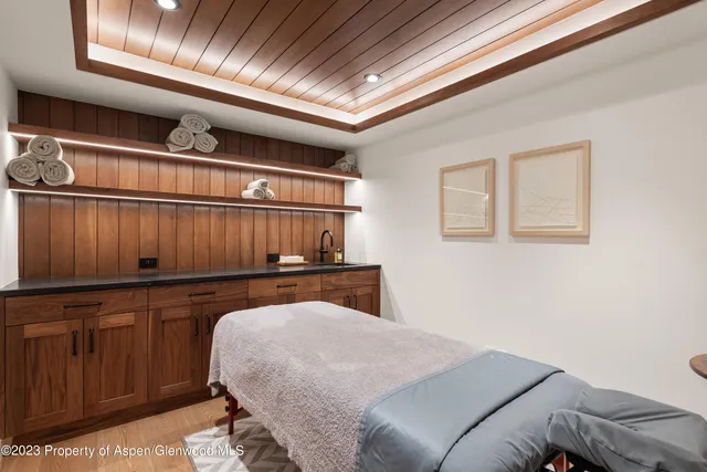 a front view of a house with a garden and trees