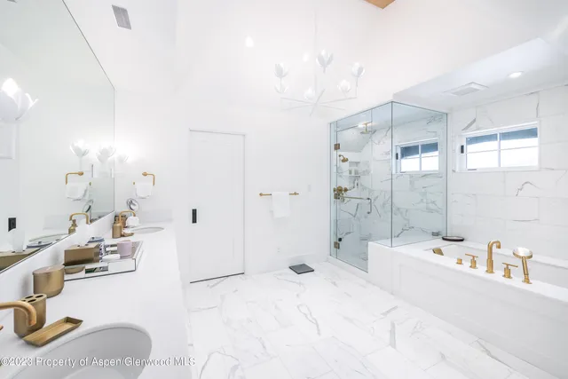 a bed room with a large bed and a fireplace