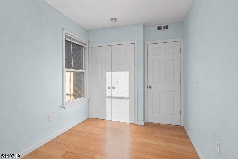 136 Smith Street Elizabeth, NJ 07201 - Photo 25 of 38 a view of an empty room with closet and a window