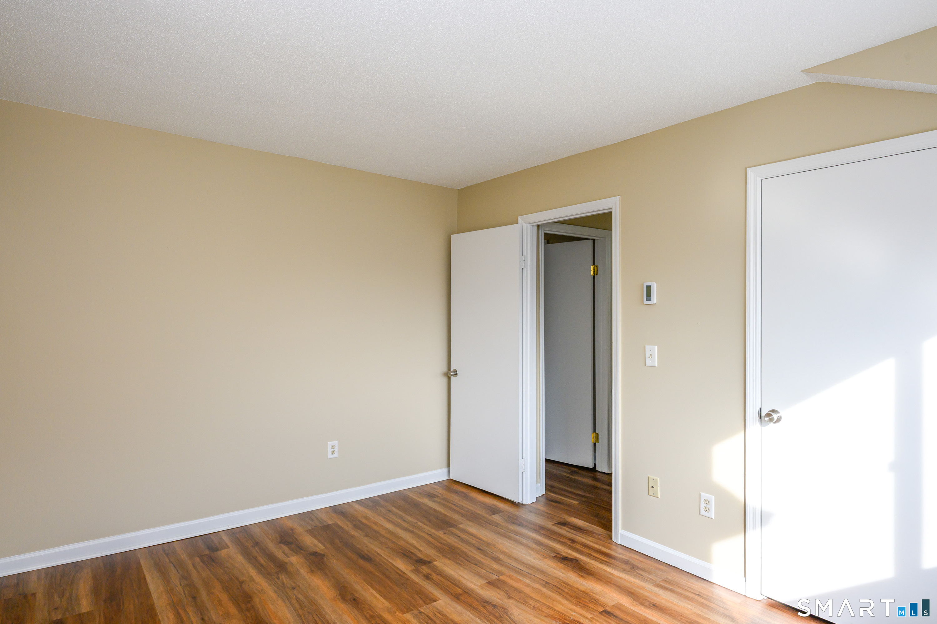 925 Oronoke Road, Unit 21A Waterbury, CT 06708 - Photo 19 of 39 a view of an empty room with wooden floor