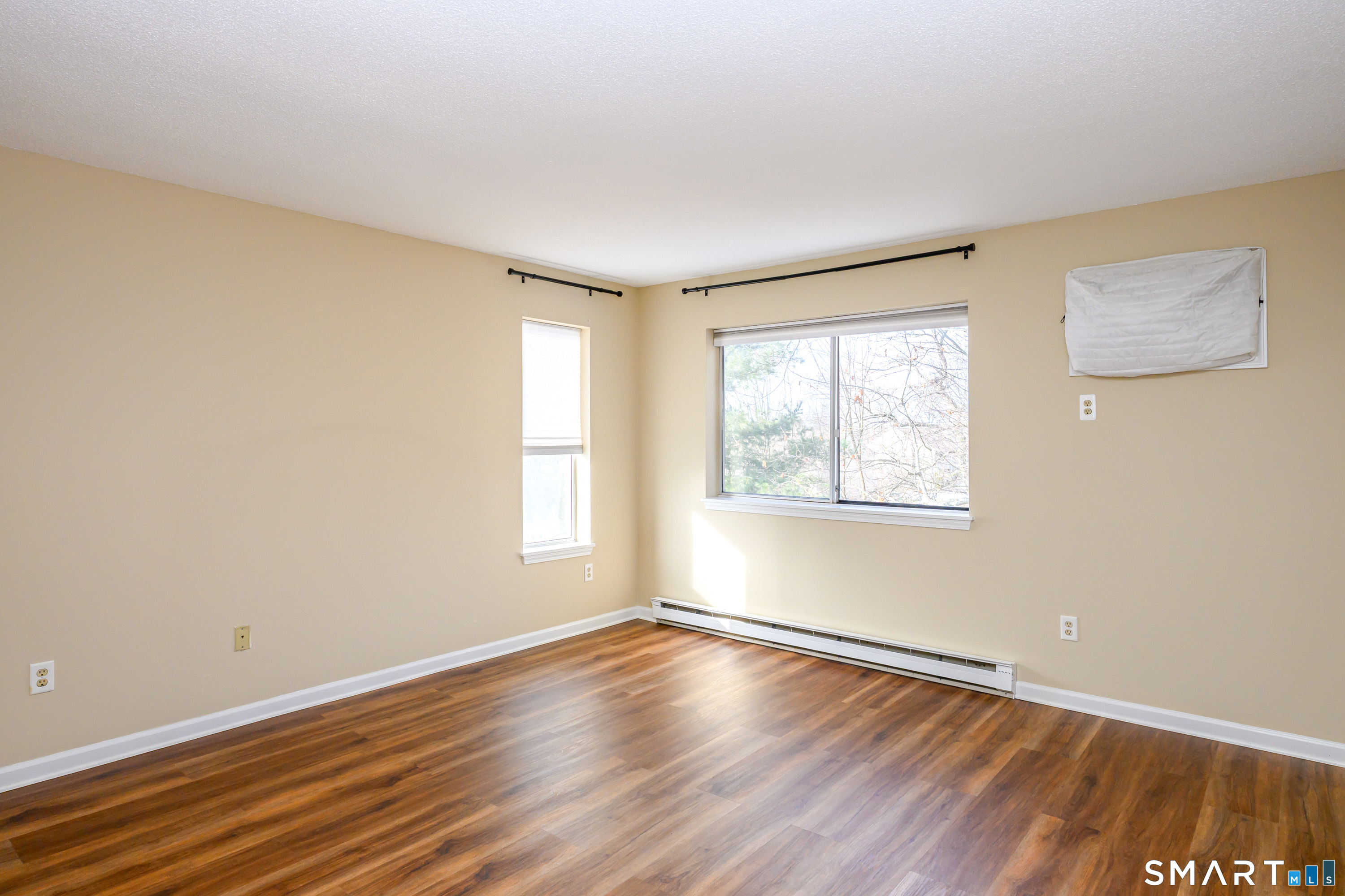 925 Oronoke Road, Unit 21A Waterbury, CT 06708 - Photo 21 of 39 a view of an empty room with wooden floor and a window