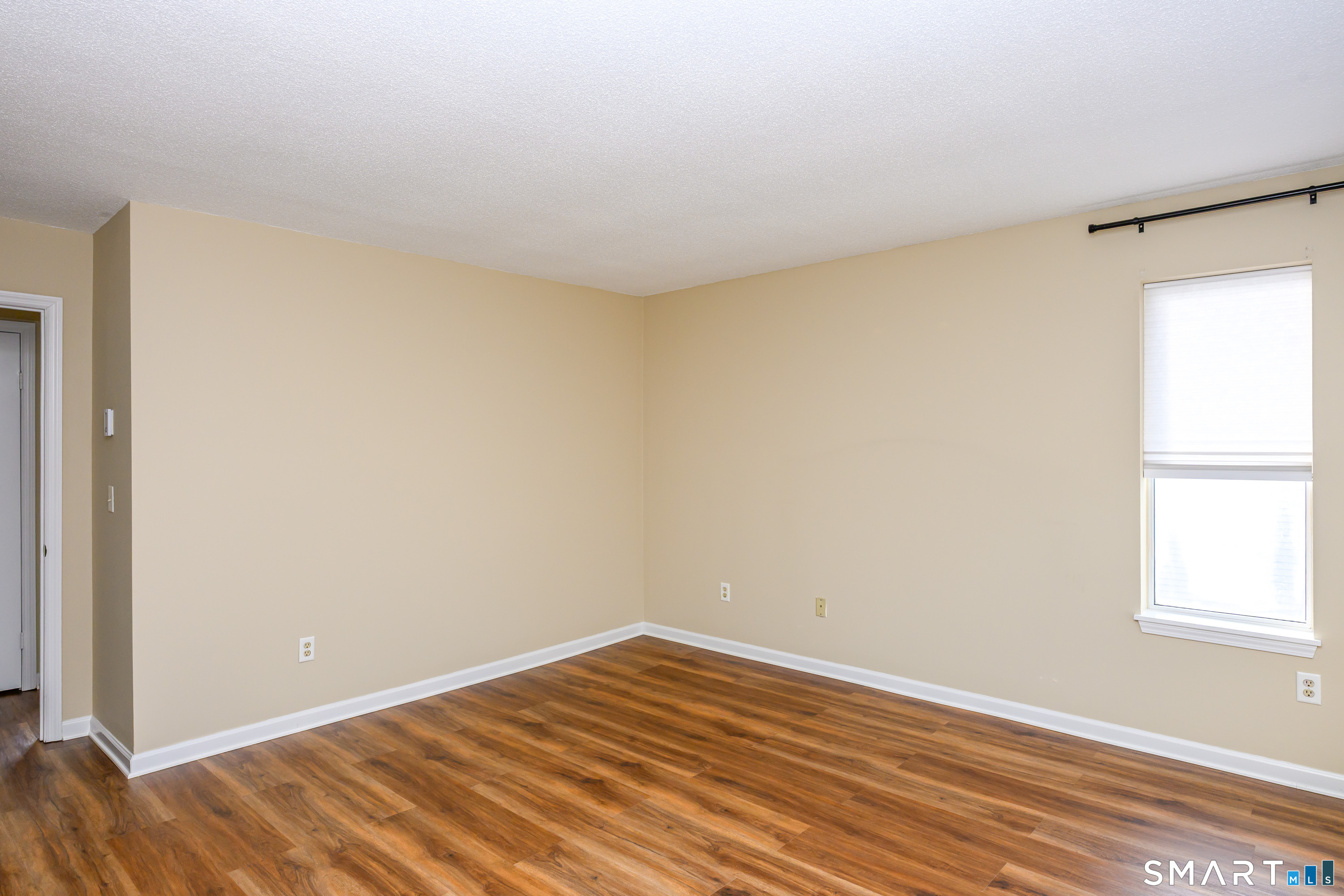 925 Oronoke Road, Unit 21A Waterbury, CT 06708 - Photo 28 of 39 a view of an empty room with wooden floor and a window