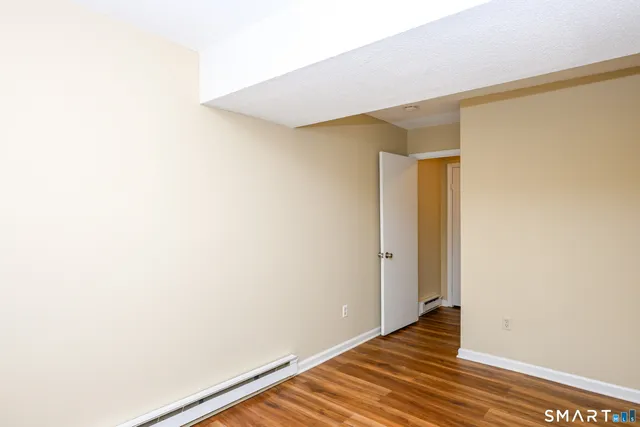 a view of hallway with wooden floor