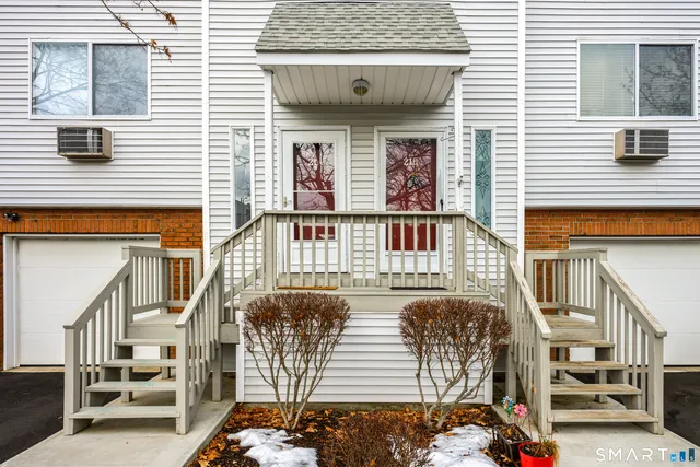a front view of a house with stairs