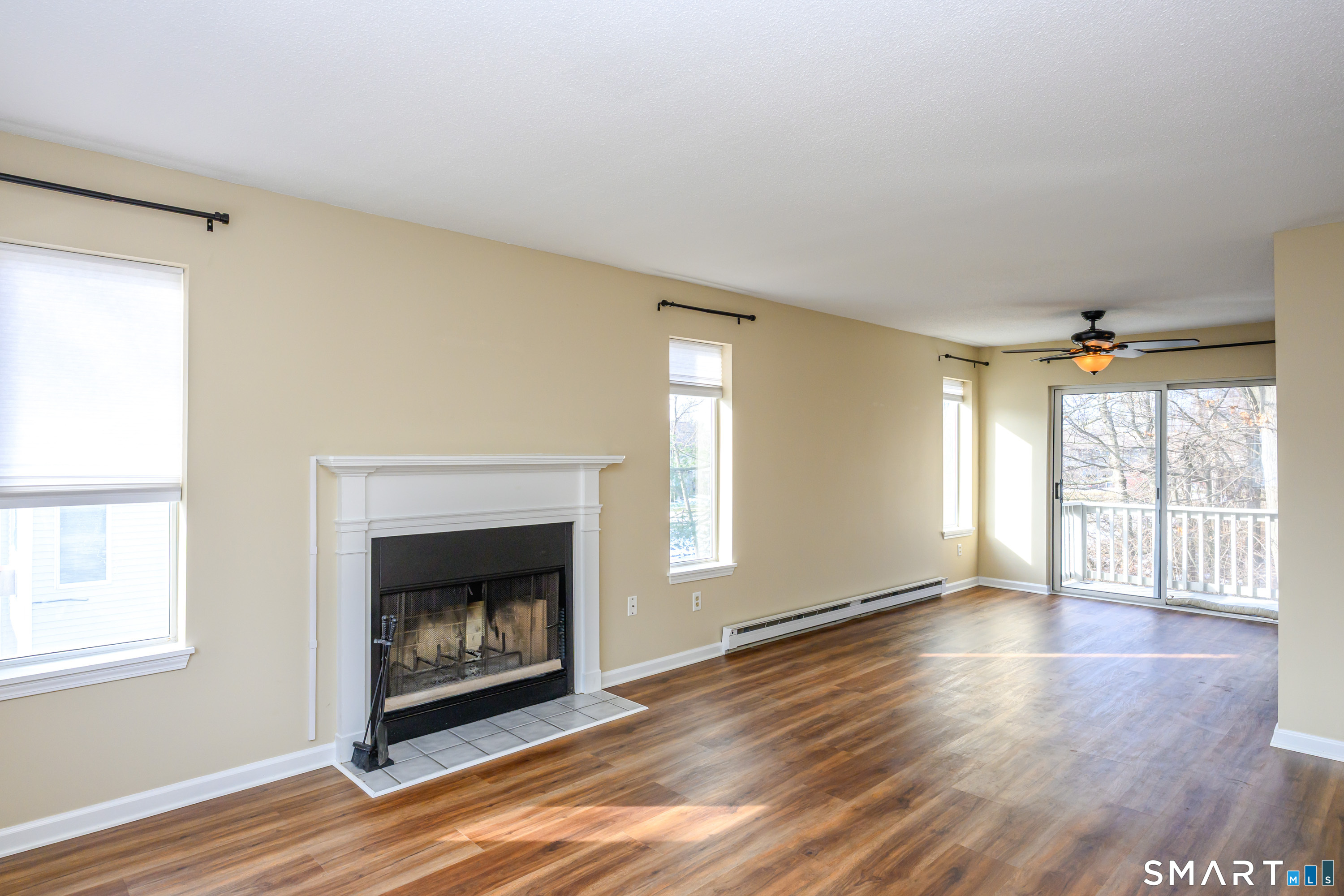 925 Oronoke Road, Unit 21A Waterbury, CT 06708 - Photo 8 of 39 a view of an empty room with wooden floor fireplace and a window