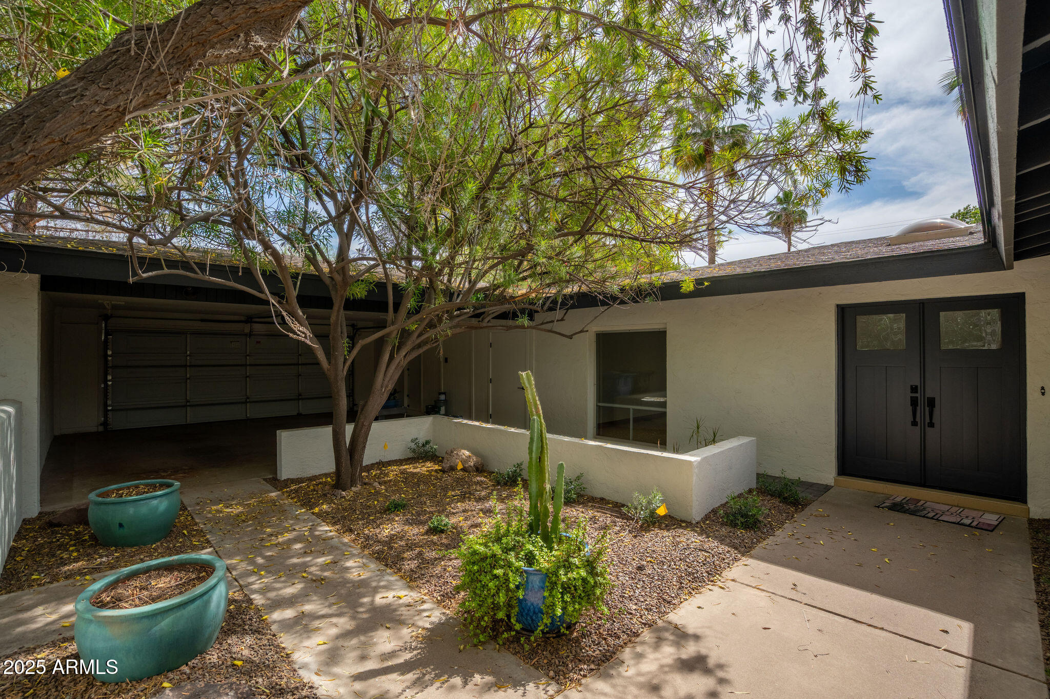 3608 North 56th Street Phoenix, AZ 85018 - Photo 1 of 18 a front view of a house with garden