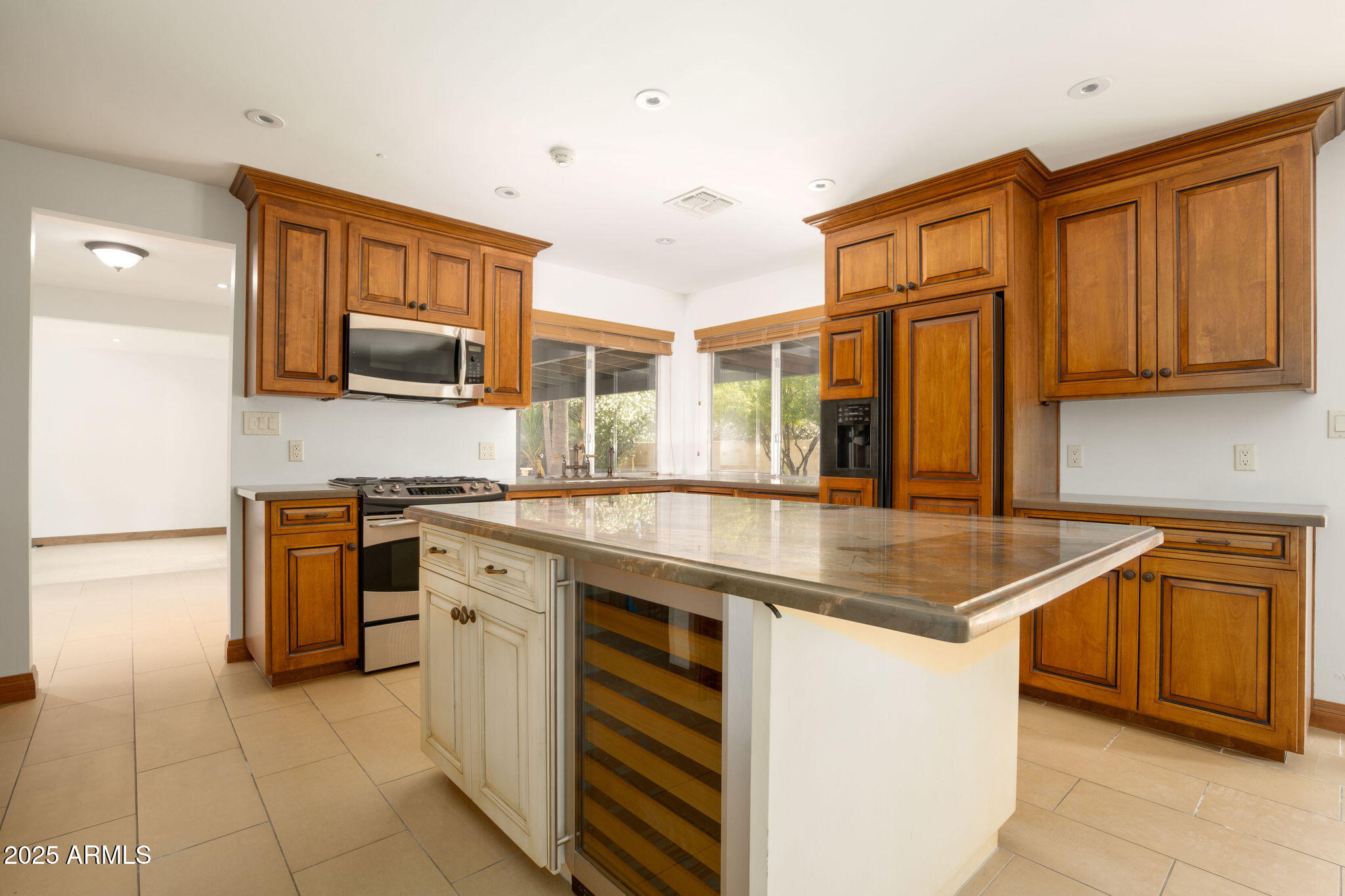 3608 North 56th Street Phoenix, AZ 85018 - Photo 3 of 18 a kitchen with stainless steel appliances granite countertop a sink stove and cabinets