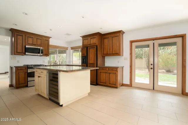 a kitchen with stainless steel appliances a stove sink and microwave