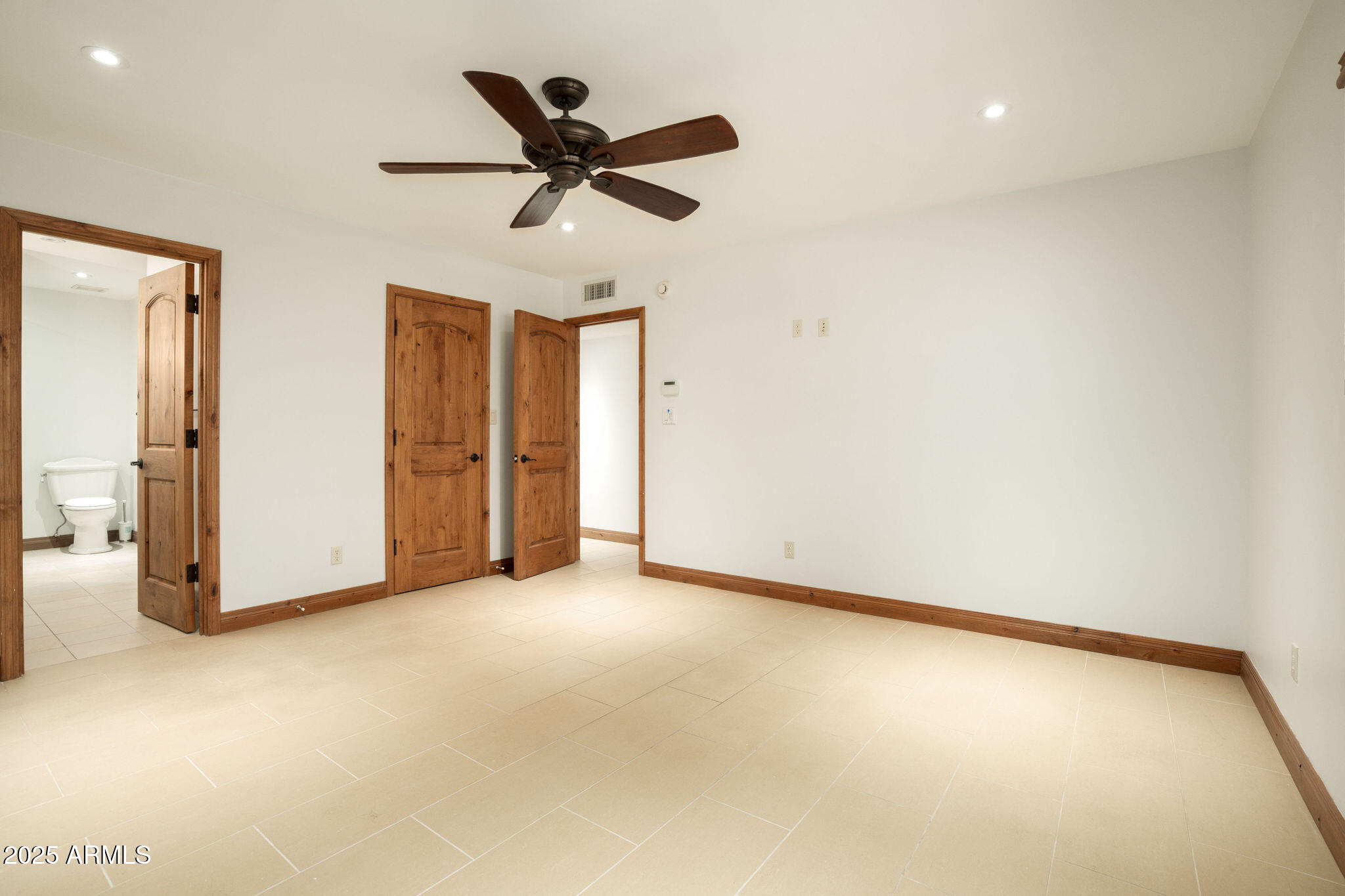 3608 North 56th Street Phoenix, AZ 85018 - Photo 8 of 18 an empty room with closet and a chandelier fan