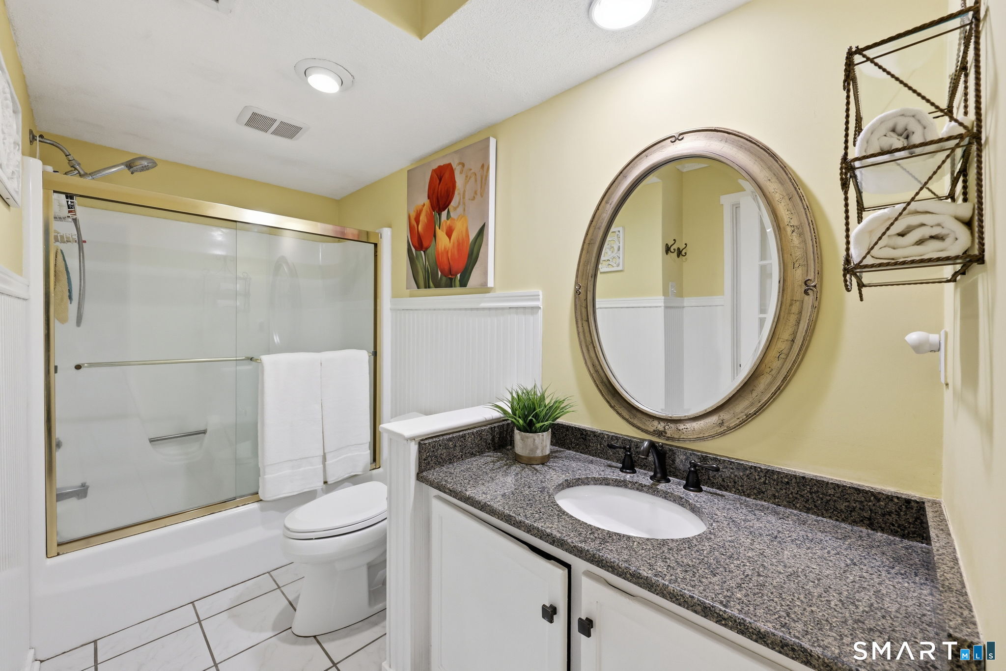 23 Maple Lane, Unit 23 Avon, CT 06001 - Photo 17 of 33 a bathroom with a granite countertop toilet a sink and a mirror