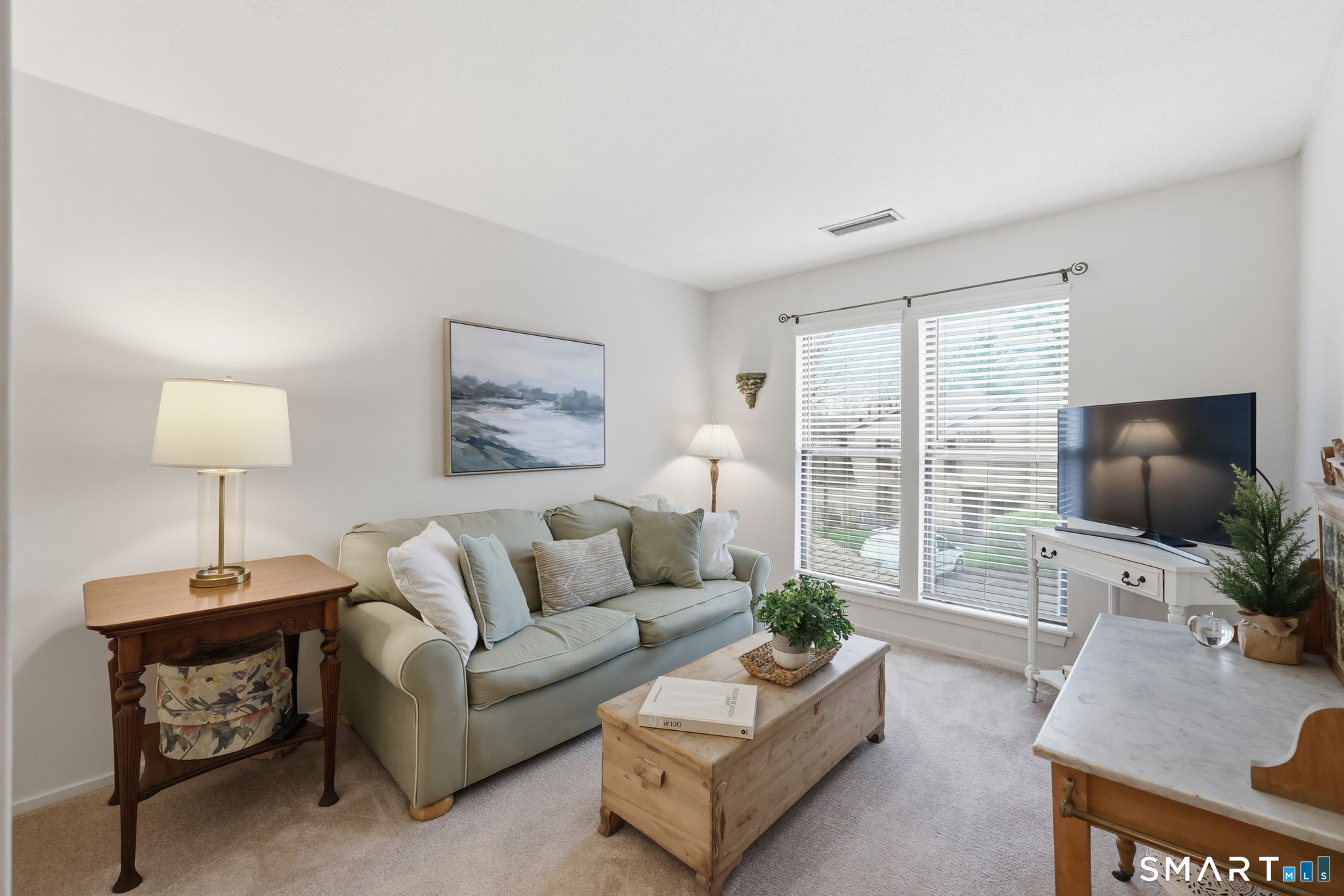 23 Maple Lane, Unit 23 Avon, CT 06001 - Photo 18 of 33 a living room with furniture a flat screen tv and a large window