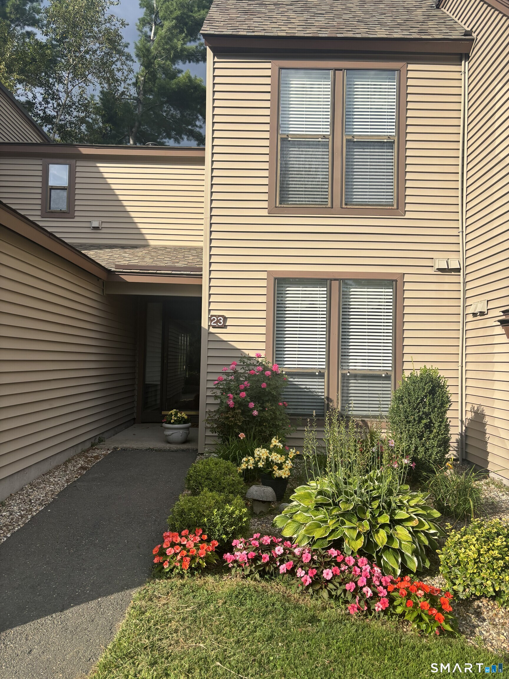 23 Maple Lane, Unit 23 Avon, CT 06001 - Photo 25 of 33 a view of a house that has a flower garden