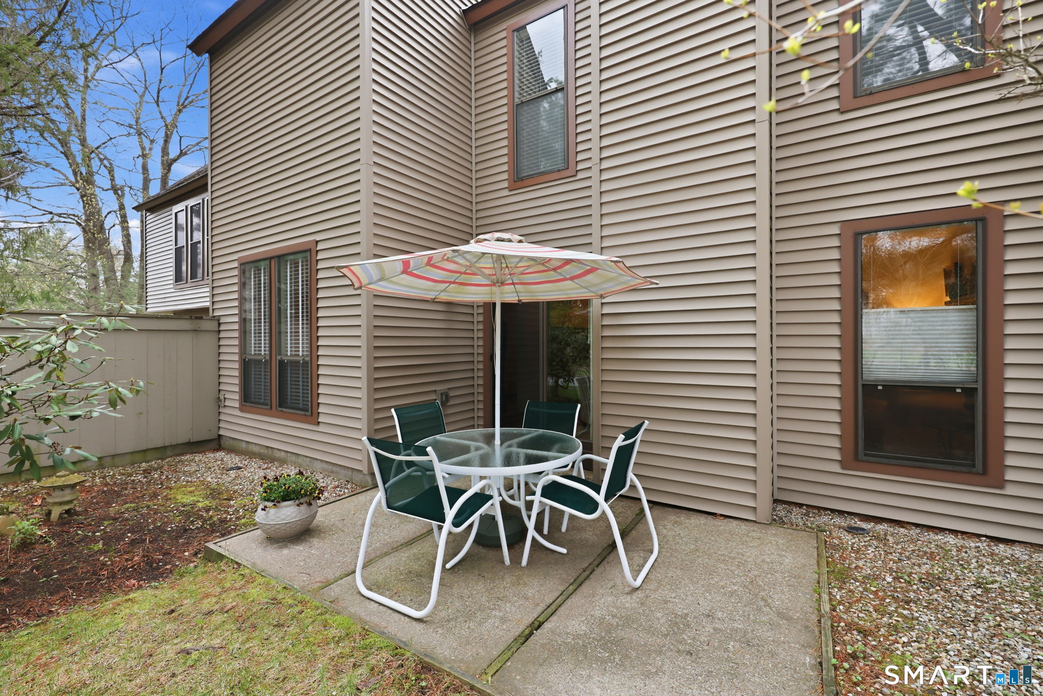 23 Maple Lane, Unit 23 Avon, CT 06001 - Photo 28 of 33 a view of a patio with a table and chairs and potted plants