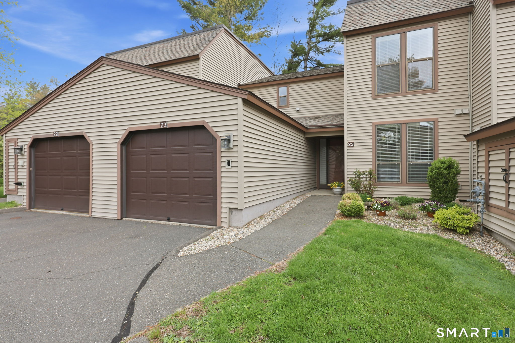 23 Maple Lane, Unit 23 Avon, CT 06001 - Photo 29 of 33 a front view of a house with a yard and garage