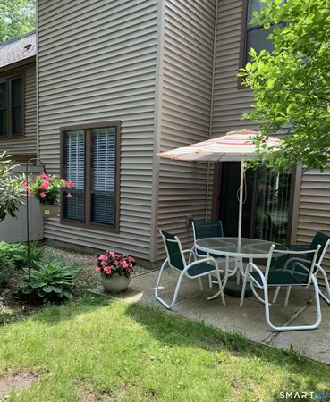 a view of a chairs and table in patio of the house